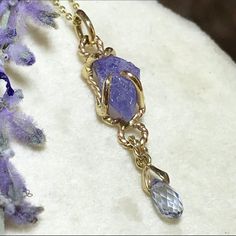 "Please go to my Instagram to watch the video about this pendant ~ A lovely genuine purple-blue color tanzanite glistens in a hollow 14k yellow gold wire bezel.  Set with a light blue color sapphire bead is so fiery, vibrant and intense!  A unique little piece with so much character. All handcrafted by me in my Michigan studio. Gem: approx. 12mm x 7mm / 2.15ct / genuine purple-blue tanzanite / with inclusions and imperfection surface            6mm x 3mm/ genuine light blue bead / with inclusion Lavender Tanzanite Jewelry For Gifts, Unique Tanzanite Jewelry Gift, Unique Tanzanite Jewelry For Gifts, Handmade Tanzanite Yellow Gold Jewelry, Necklace Sapphire, Boulder Opal Ring, Halo Necklace, 14k Yellow Gold Necklace, Yellow Gold Necklace