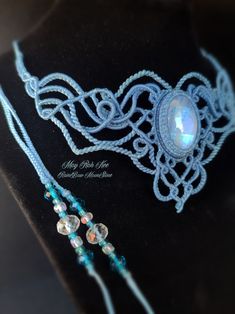 a close up of a necklace on a mannequin headpiece with beads and glass beads