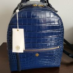 New With Tags. Retails $495 Color: Navy Blue Measurements: Approx 2" Top Handle Drop Length Approx 11.16" Height X 9.56" Width X 4.78" Depth Cross Posted Tory Burch Backpack, Tory Burch Kira Chevron, Kira Chevron, Mini Backpack Purse, Orange Backpacks, Tory Burch Kira, Grey Backpacks, Flap Backpack, Brown Leather Backpack