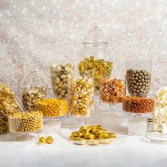 a table topped with lots of different types of candy and candies in glass containers