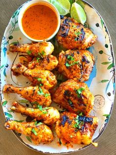 grilled chicken wings with dipping sauce on a plate