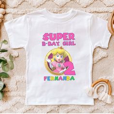 Peach Birthday Shirt, Gamer Girl Birthday Shirt, Girl Birthday Shirts, Custom Shirt, Girls 7th Birthday Shirts, Mario Gamer Birthday Shirt. Mario Birthday Shirt, Super Smash Party, Video Game, Princess Peach Shirt, Custom Birthday Shirt, Kids Unisex ,  H O W -T O-O R D E R: 1) Check and Review all Photos. 2) Select Your T-Shirt Size and T-Shirt Color from drop down menus. 3) Choose Your Quantity you want. 4) Don't forget fill the personalization box with this info: NAME, AGE AND GENDER.  5) Clic Princess Peach Birthday Outfit, Princess Peach Birthday Shirt, Mario Shirts Birthday, Super Mario Shirts Birthday, Princess Peach Shirt, Mario Kart 5th Birthday Shirt, Girls 7th Birthday, Peach Birthday, Gamer Birthday