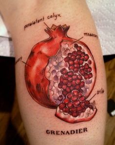 a pomegranate tattoo with the words, granadier written below it