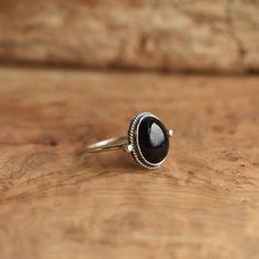 This is a perfect dainty black ring - .925 Sterling Silver - Black Onyx Sometimes you want to gaze down at your ring and see perfect balance and grace. That's what the Delica Dainty Ring has to offer. High- grade Black Onyx with a simple, sterling silver design. Perfect little ring. Lovely, traditional, dainty ring of 10 x 12mm Black Onyx cabochon set in .925 sterling silver oxidized and burnished bezel and wire. Simple, elegant and perfect. This lovely little ring is created using traditional s Classic Adjustable Black Enamel Rings, Black Sterling Silver Stackable Open Rings, Adjustable Onyx Rings With Black Enamel, Black Sterling Silver Stackable Rings As Gift, Black Sterling Silver Stackable Rings For Gift, Adjustable Black Enamel Onyx Rings, Adjustable Black Stackable Open Rings, Handmade Black Crystal Promise Ring, Black Open Midi Rings For Promise