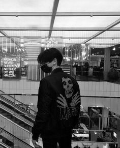 a man standing on top of an escalator