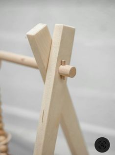 a close up of a wooden object on a chair with wood dows in the background