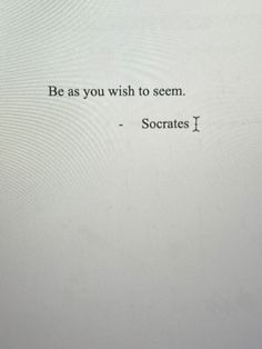 the words be as you wish to seem soccrats i are written in black ink