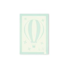 a white and blue hot air balloon on a light green background with stars around it