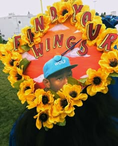 a person with sunflowers on their head and the words find your wings up