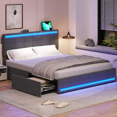 a bed that has some lights on the headboard and night stands in front of it