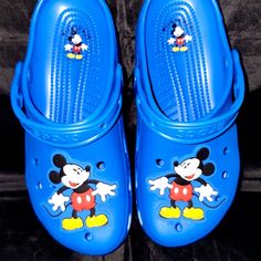 Step Into The Magic Of Disney With These Brand New 2024 Mickey Mouse Adult Clogs From Crocs. Made With The Highest Quality Materials, These Blue Clogs Feature The Iconic Mickey Mouse Ears Design, Making Them The Perfect Souvenir For Any Disney Fan. Ideal For Both Indoor And Outdoor Use, These Comfortable Clogs Are Perfect For Everyday Wear Or For Adding A Touch Of Disney Magic To Your Next Park Visit. With A Size Of M7/W9, They Are Sure To Fit Comfortably. Don't Miss Out On This Amazing Opportun Casual Mickey Mouse Clogs With Round Toe, Cute Blue Non-slip Clogs, Cute Blue Round Toe Sandals, Fun Blue Non-slip Clogs, Blue Non-slip Fun Clogs, Playful Blue Round Toe Clogs, Cute Non-slip Blue Sandals, Blue Fun Slip-on Clogs, Fun Blue Slip-on Clogs