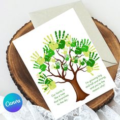 a card with handprints on it sitting on top of a piece of wood