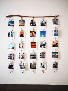 several pictures hanging on a wall with clothes pins attached to them and photos pinned to the wall