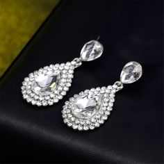 Level up looks with luxurious style by donning these earrings enriched with glittering cubic zirconia stonework. 0.75'' W x 1.57'' L Silver-plated copper / cubic zirconia /?crystal Diamond White Crystal Drop Earrings With Cubic Zirconia, Diamond Drop Earrings With Rhinestones, Bridal Diamond Drop Earrings With Rhinestones, Diamond White Earrings With Rhinestones, Diamond White Crystal Drop Bridal Earrings, Crystal Drop Earrings For Anniversary, White Sparkling Crystal Teardrop Earrings, Sparkling White Crystal Teardrop Earrings, White Crystal Teardrop Earrings With Sparkle