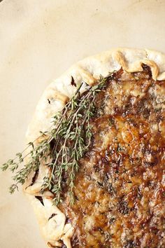 an uncooked pie with herbs on top