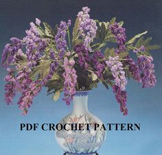 a white vase filled with purple flowers on top of a blue table next to the words pdf crochet pattern