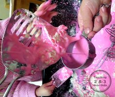 a person is using a pink mixer to make cake