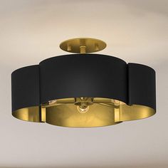 a black and gold circular light fixture hanging from the ceiling