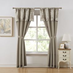 a living room with a window and curtains