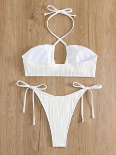 Soak up the sun in the Coco Bikini Set, where chic meets comfort in a luxurious package. This alluring white two-piece features a textured fabric with a hint of shimmer, halter neck ties for the perfect fit, and charming side-tie bottoms that offer both style and adjustability. Make a splash with its flattering ruched detailing and delicate front clasp, ensuring you're the embodiment of poolside grace. Specs: Material: Polyester Chic White Swimwear With Tie Back, White Triangle Top Swimwear With String Tie, White Backless Swimwear With Tie Back, White String Tie Swimwear For Beach Season, White Halter Neck Swimwear With Tie Back, White Beachwear Halter Top For Party, Chic White Tie Back Swimwear, Chic White Tie-back Swimwear, White Tie-back Backless Swimwear