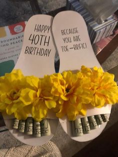 two flip flops decorated with yellow flowers and the words happy birthday written on them