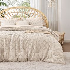 the bed is made up with white sheets and beige comforters, along with a wicker headboard