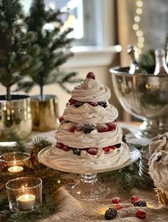 a christmas tree made out of meringue and strawberries on a table with candles