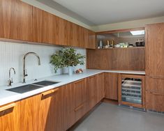 a kitchen with wooden cabinets and white counter tops