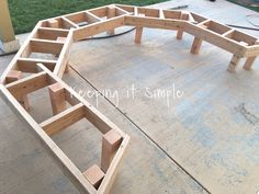 a wooden bench sitting on top of a cement floor