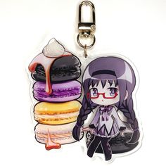 a key chain with an anime character holding a doughnut