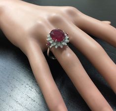 6.65 Carats Impressive Red Ruby and Diamond 14K White Gold Ring Suggested Replacement Value $4,800.00 Total Red Ruby Weight is: Approx. 6.00 Carats (lead glass filled) Ruby Measures: 11 x 9mm Natural Round Diamonds Weight: Approx. 0.65 Carats (color G-H / Clarity SI1-SI2) Ring total weight: 5.8 grams Disclaimer: all weights, measurements and colors are approximate and may vary slightly from the listed dimensions or as seen in the image. All pictures are magnified to show the smallest of details. Luxury Red Ruby Ring For Formal Occasions, Luxury Red Ruby Round Ring, Red Ruby Round Ring, Luxury, Red Ruby Ring With Halo Setting For Formal Occasions, Luxury Red Cluster Diamond Ring, Red Ruby Ring In Luxury Style, Red Diamond Cluster Ring With Vvs Clarity, Gia Certified Red Diamond Ring For Formal Occasions, Formal Red Gemstone Brilliant Cut Diamond Ring