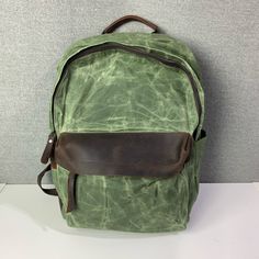 Gorgeous Green Waxed Canvas Backpack With Leather Accents. Two Water Bottle Pockets And Some Small Accessory Pockets On The Inside, And Hidden Pocket On The Back. Brand New, Never Used. Casual Leather Backpack With Waxed Finish, Vintage Green Backpack For Everyday Use, Everyday Large Capacity Waxed Canvas Backpack, Casual Leather Bag With Leather Patch, Casual Waxed Canvas Bag With Leather Patch, Green Leather Backpack With Leather Handles, Coated Canvas Backpack With Large Capacity, Casual School Bag With Waxed Finish, Casual Coated Canvas Backpack For Daily Use