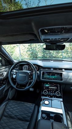 the interior of a car with all black leather seats and dashboards, including an electronic display