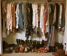 a closet filled with lots of different types of shoes and clothing hanging on the wall