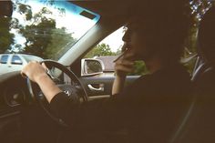 a woman driving her car talking on the phone