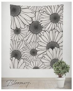 a white wall with black and white flowers on it