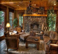 a living room filled with lots of furniture and a fire place in the middle of it