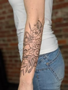 a woman with a flower tattoo on her arm