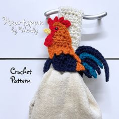 a crochet chicken is hanging on a towel rack with the words heartspun by wendy written below it