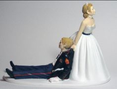 a figurine of a man laying on the ground next to a woman in a wedding dress