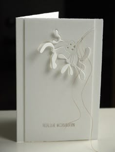 a white card with an intricate design on it