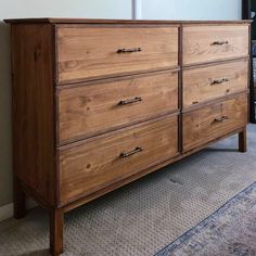 a large wooden dresser sitting on top of a carpeted floor