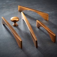 three different types of wooden handles on a table