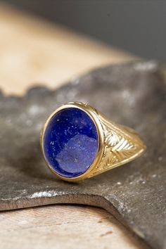 A beautiful signet ring with carvings on the sides made by hand and a cabochon lapis lazulis gemstone in the center. *real images of the ring, taken by us* Lapis Lazuli Stone Size: 14x12mm Material: - Sterling Silver 925 - 9K Gold (375) - 14K Gold (585) - 18K Gold (750) *All signet rings are hallmarked on the back for certification* - We offer FREE Worldwide DHL & FedEx Shipping! - Branded DanelianJewelry Gift Box with each order! Classic Lapis Lazuli Ring With Polished Finish, Classic Lapis Lazuli Jewelry Ring, Carved 14k Gold Signet Ring As Gift, Luxury Carved Blue Jewelry, Luxury Blue Carved Jewelry, Classic Carved Ceremonial Jewelry, Classic Lapis Lazuli Ring As A Gift, Classic Lapis Lazuli Ring As Gift, Oval Carved Signet Ring For Anniversary