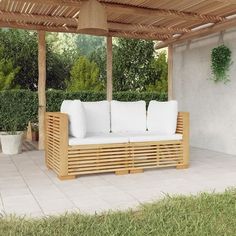 a wooden couch sitting under a pergolated roof