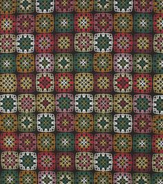 an image of a multicolored patchwork pattern on black fabric with white, red, green, and yellow squares