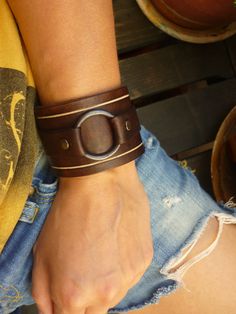 This bracelet is carefully crafted on 3mm brown vacchetta leather (0.12 in). The leather is very durable and can get wet without getting damaged or faded. PLEASE MEASURE YOUR WRIST FOR THE CLOSEST FIT. Metal snap button make it easy to put on and off. The width is 4,6cm (1,8 in). Simple but very urban feel. For more bracelets view here: https://www.etsy.com/shop/OUSI?section_id=18230067&ref=shopsection_leftnav_2 For more of my handmade leather goods, just click on the links below: Shop Home Brown Leather Cuff Jewelry, Modern Brown Leather Bracelet With Wrist Strap, Handmade Modern Brown Cuff Bracelet, Modern Handmade Brown Cuff Bracelet, Leather Bangle Bracelet, Brown Leather Cuff Bracelet For Everyday, Everyday Brown Leather Cuff Bracelet, Modern Brown Cuff Jewelry, Rugged Brown Leather Bracelet