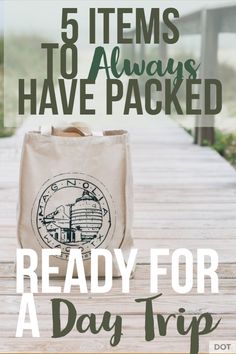 a tote bag sitting on top of a wooden table with the words ready for a day trip