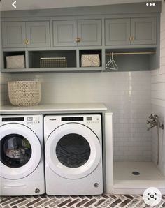 a washer and dryer in a room with white tile flooring, built - in shelving