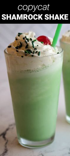 two green drinks with whipped cream and sprinkles on the top are shown